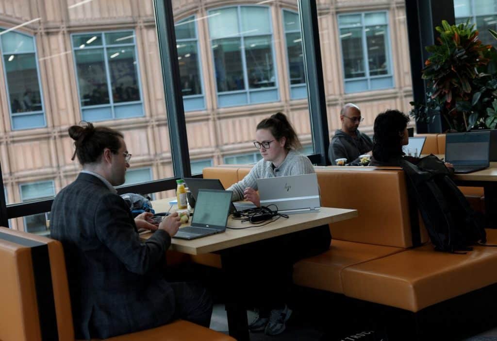 British small business owner utilizing UK GDPR compliant AI productivity tools and accounting software in a modern office environment.