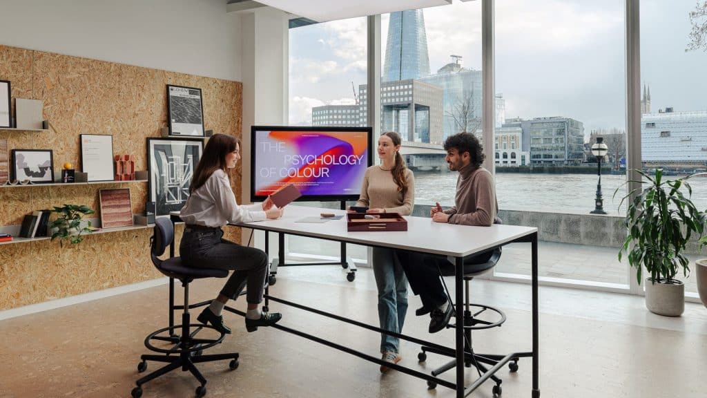 How Much Time Can AI Save British Workers? British office worker using generative AI productivity software on a laptop in a London business district. how much time does AI save workers UK