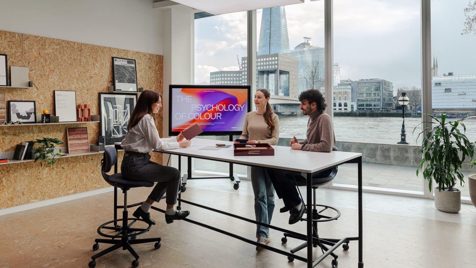 British office worker using generative AI productivity software on a laptop in a London business district. how much time does AI save workers UK