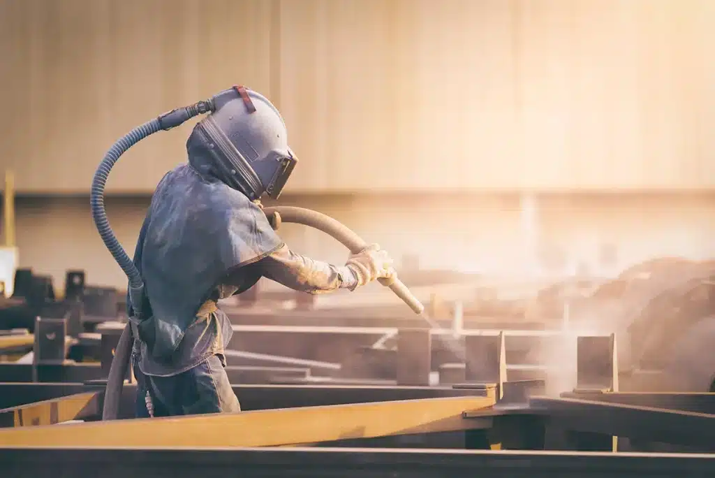 Why Professional Surface Preparation Is Essential for Long-Lasting Results Professional surface preparation of an industrial metal surface before coating